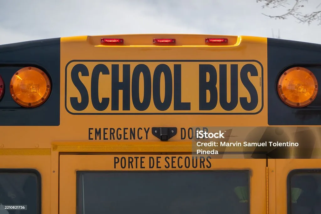 Close-up of school bus eight-light warning system showing amber and red lights