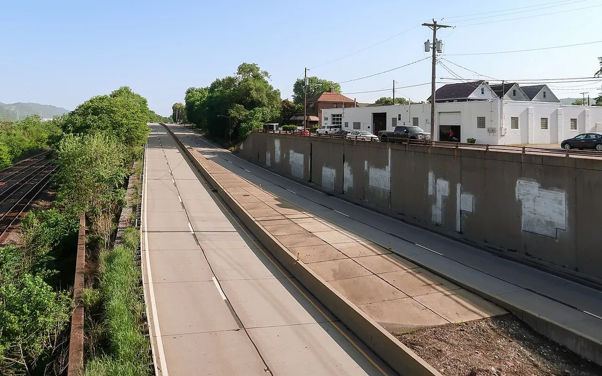 Divided highway with raised concrete median and oncoming traffic