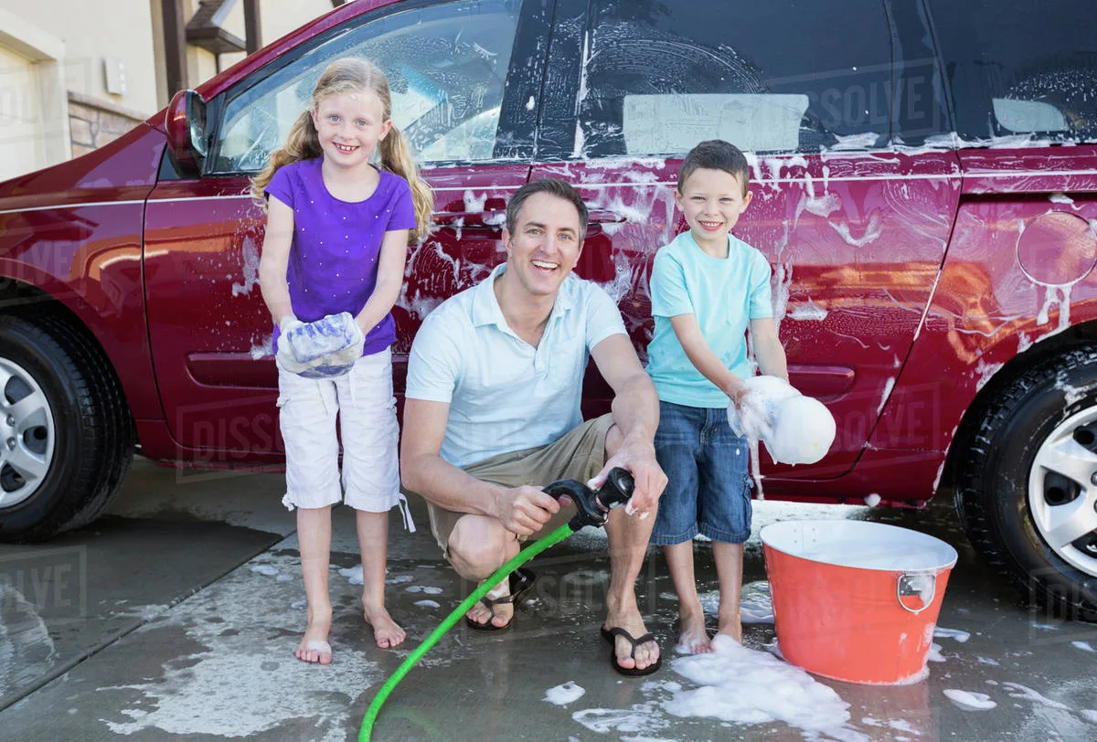 parent volunteer supervising children car wash
