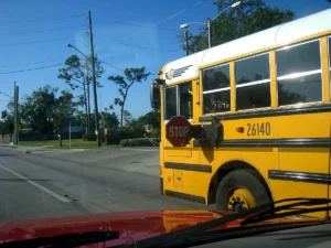 School bus with stop arm and flashing red lights