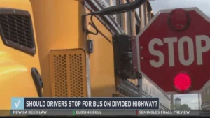 Iowa school bus stop law divided highway unpaved median