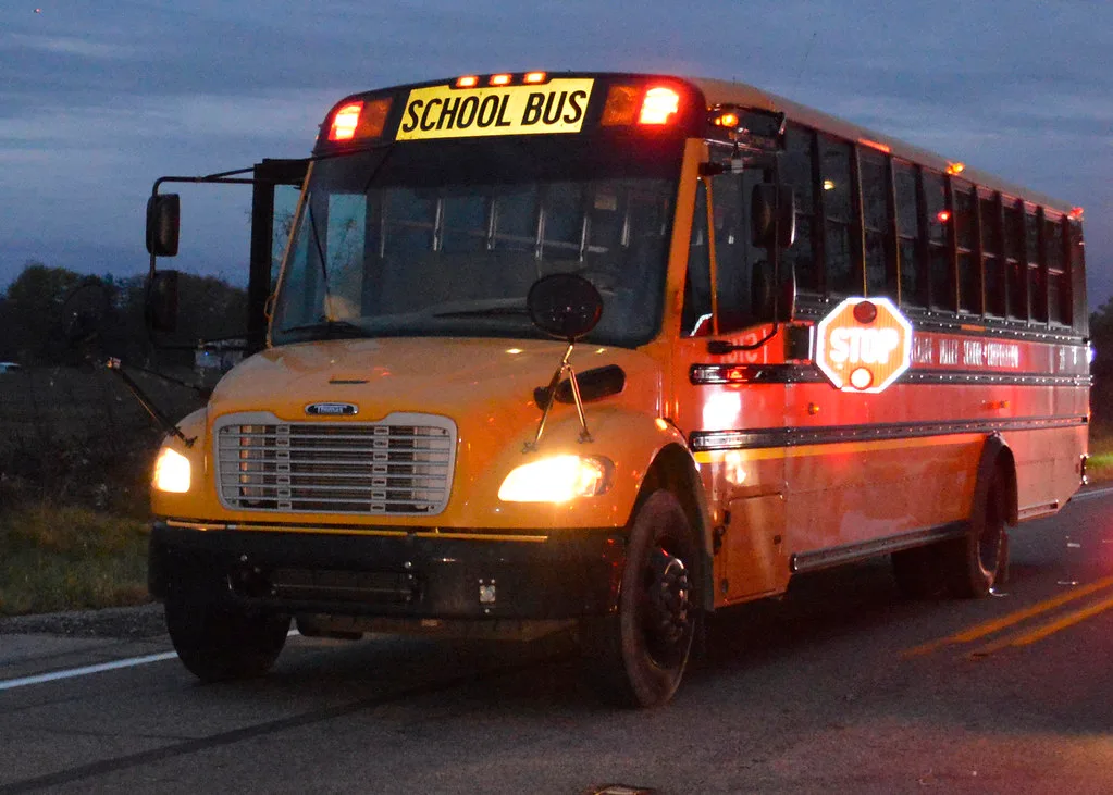 school bus stop arm flashing red lights