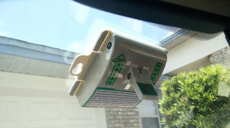 SunPass transponder mounted on car windshield