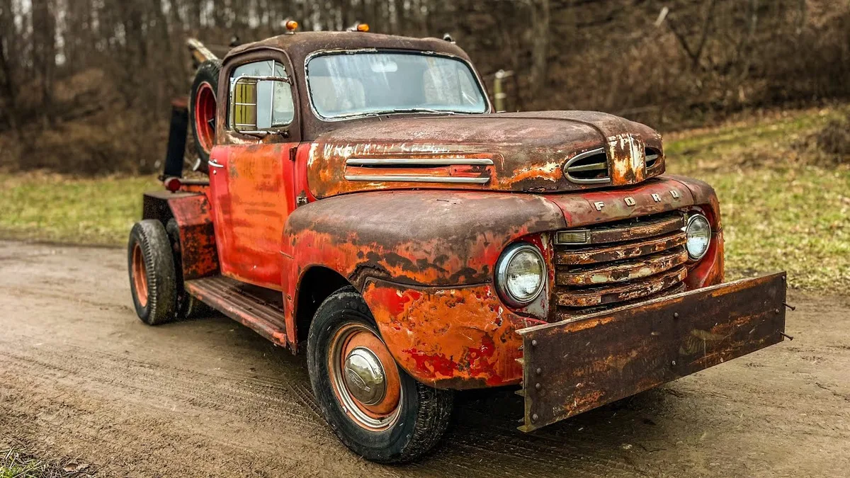 tow truck towing abandoned car