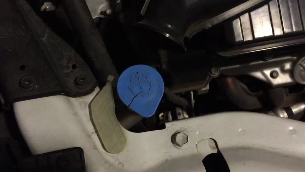 where do you pour the windshield washer fluid in a car?