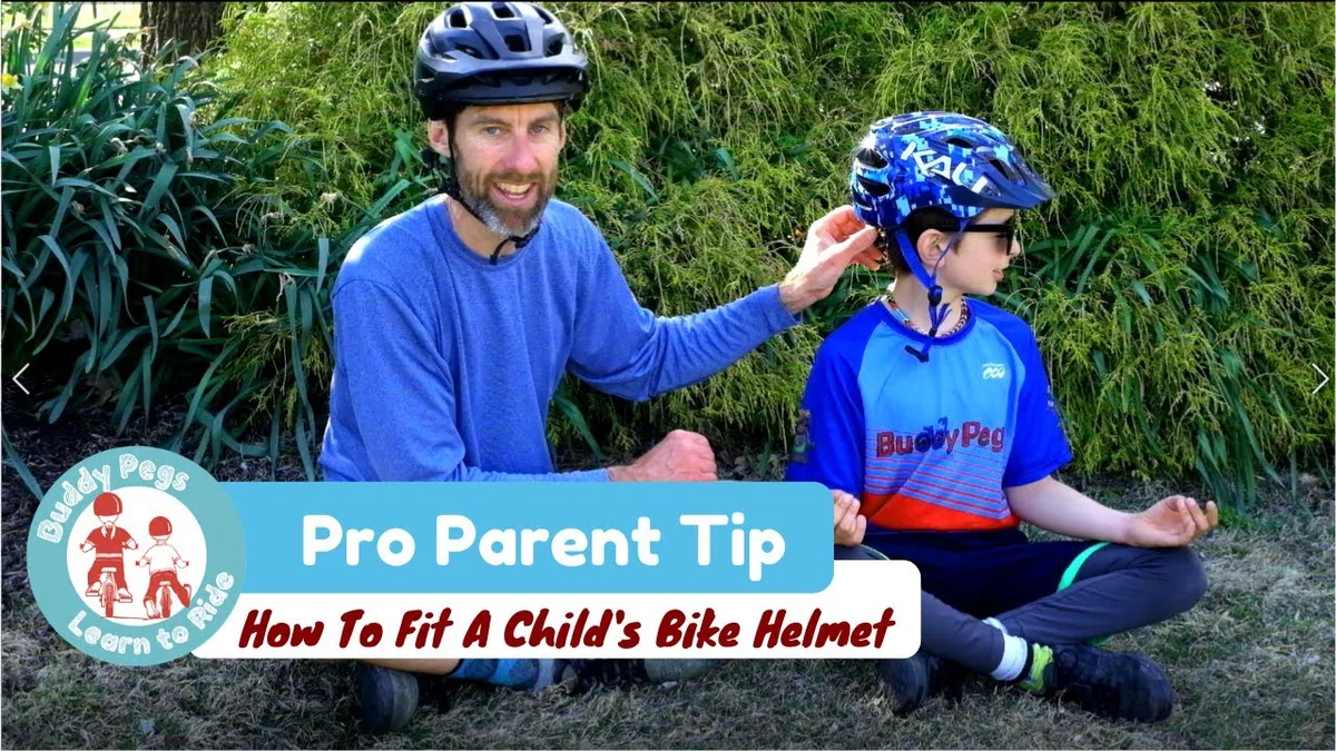 parent fitting motorcycle helmet on teen