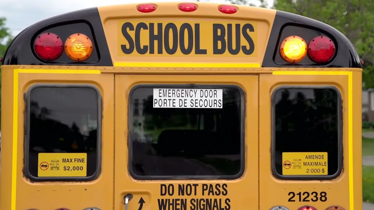 school bus flashing amber and red lights